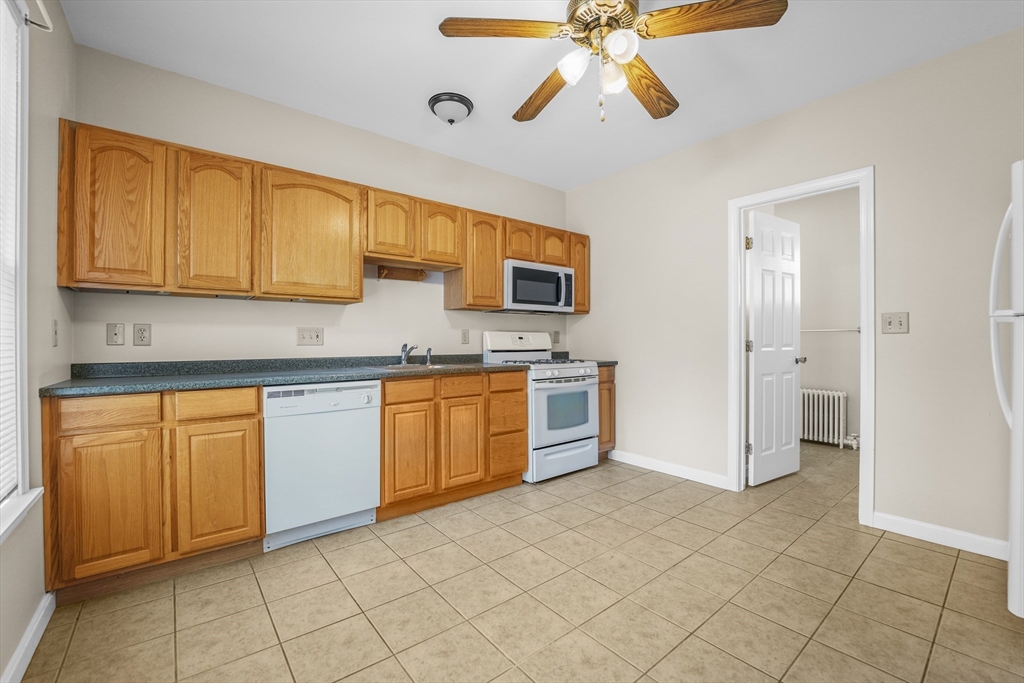 216 Grove Street Fall River, MA 02720 - Photo 16 of 26 a kitchen with stainless steel appliances granite countertop a stove a sink and a refrigerator
