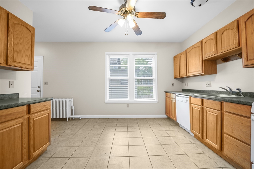 216 Grove Street Fall River, MA 02720 - Photo 17 of 26 a large kitchen with stainless steel appliances granite countertop a stove a sink and a white cabinets