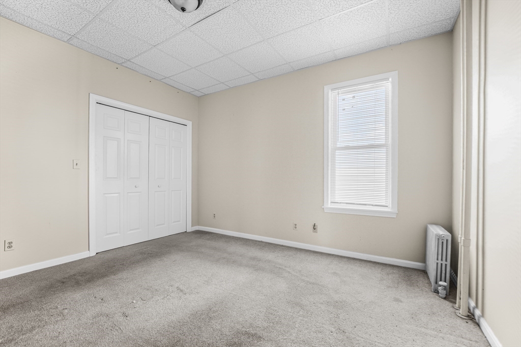 216 Grove Street Fall River, MA 02720 - Photo 21 of 26 an empty room with windows