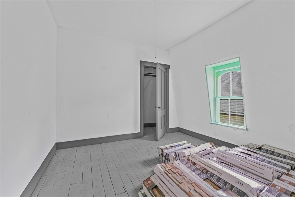 216 Grove Street Fall River, MA 02720 - Photo 26 of 26 a bedroom with a bed and wooden floor