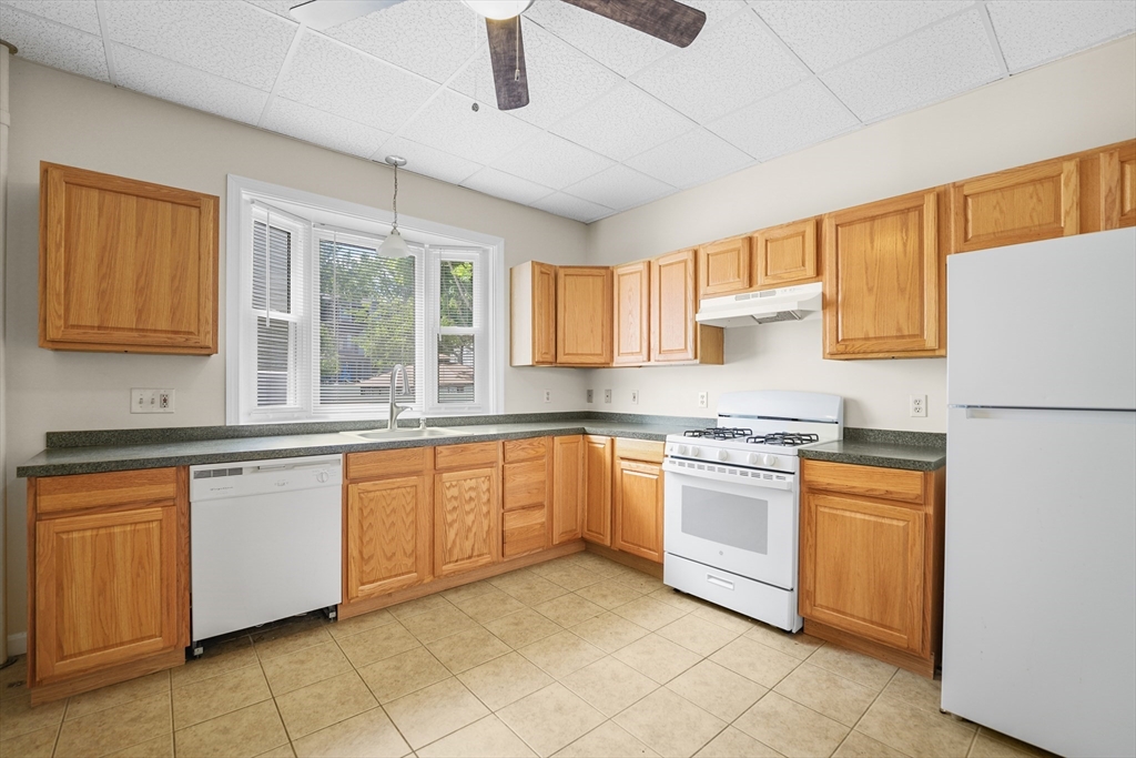216 Grove Street Fall River, MA 02720 - Photo 8 of 26 a kitchen with stainless steel appliances granite countertop a stove sink and cabinets