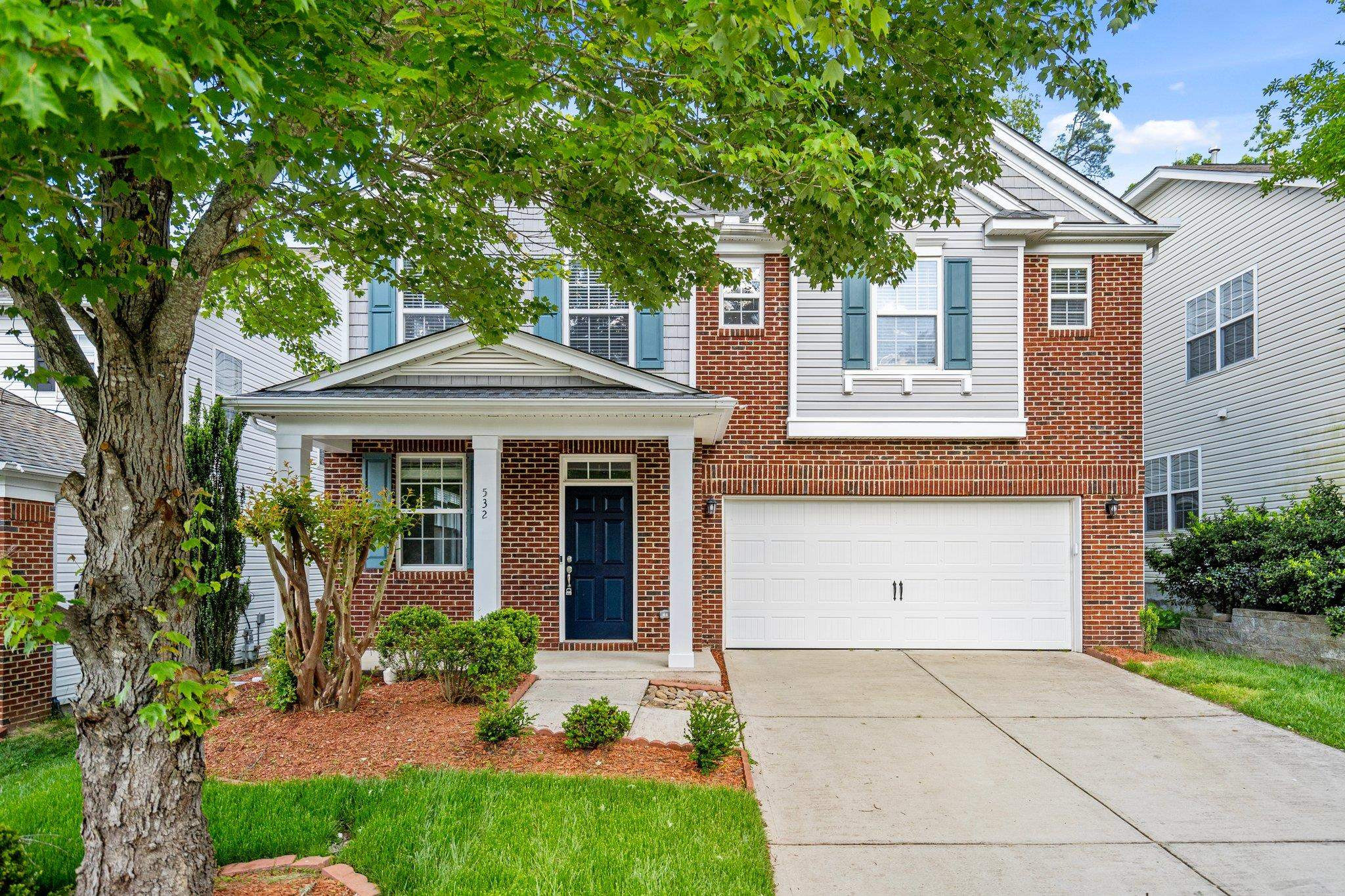 532 Emerald Downs Road Cary, NC 27519 - Photo 1 of 51 a front view of a house with a yard and a garage