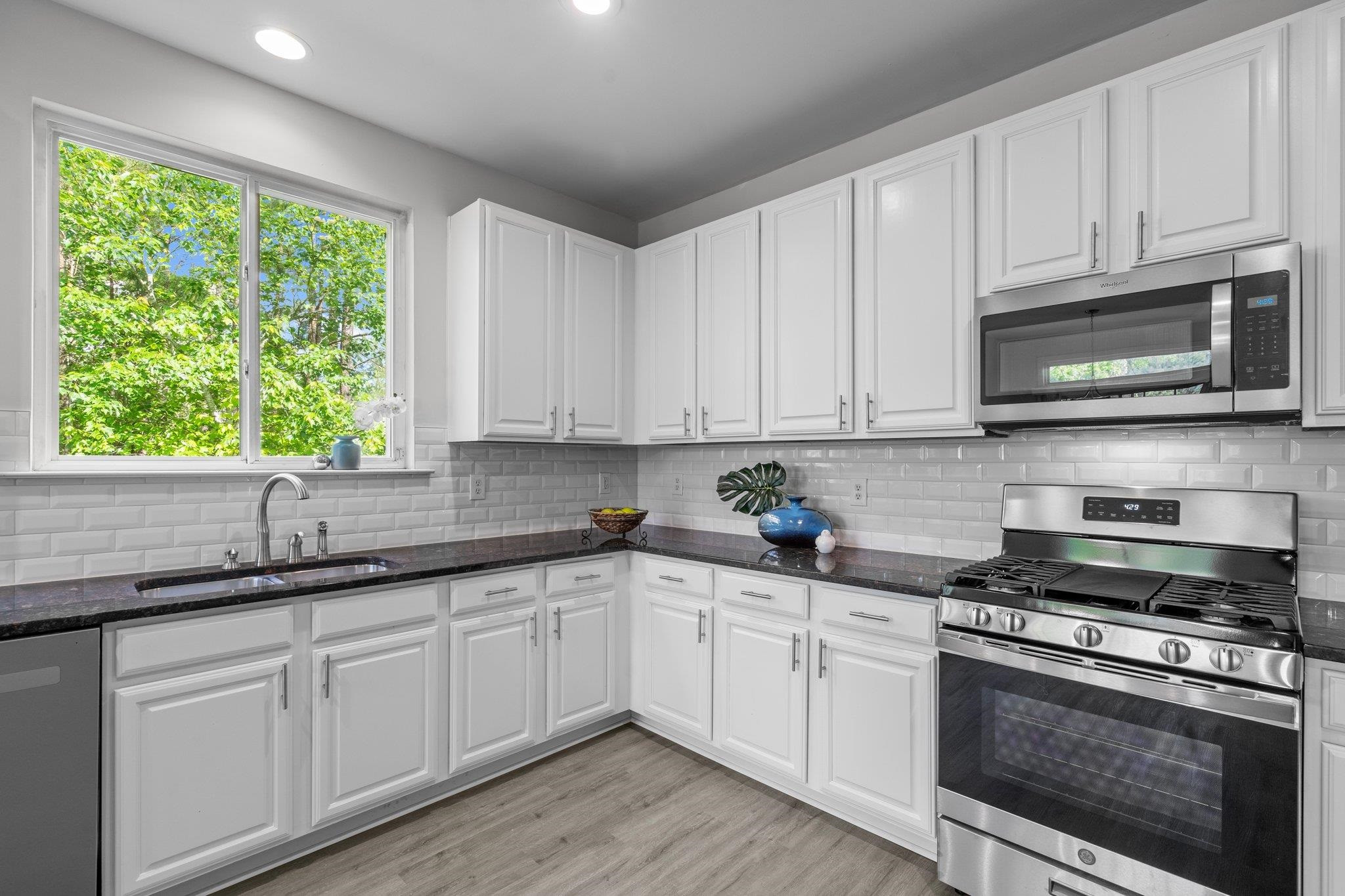 532 Emerald Downs Road Cary, NC 27519 - Photo 22 of 51 a kitchen with stainless steel appliances granite countertop white cabinets granite counter tops and a window