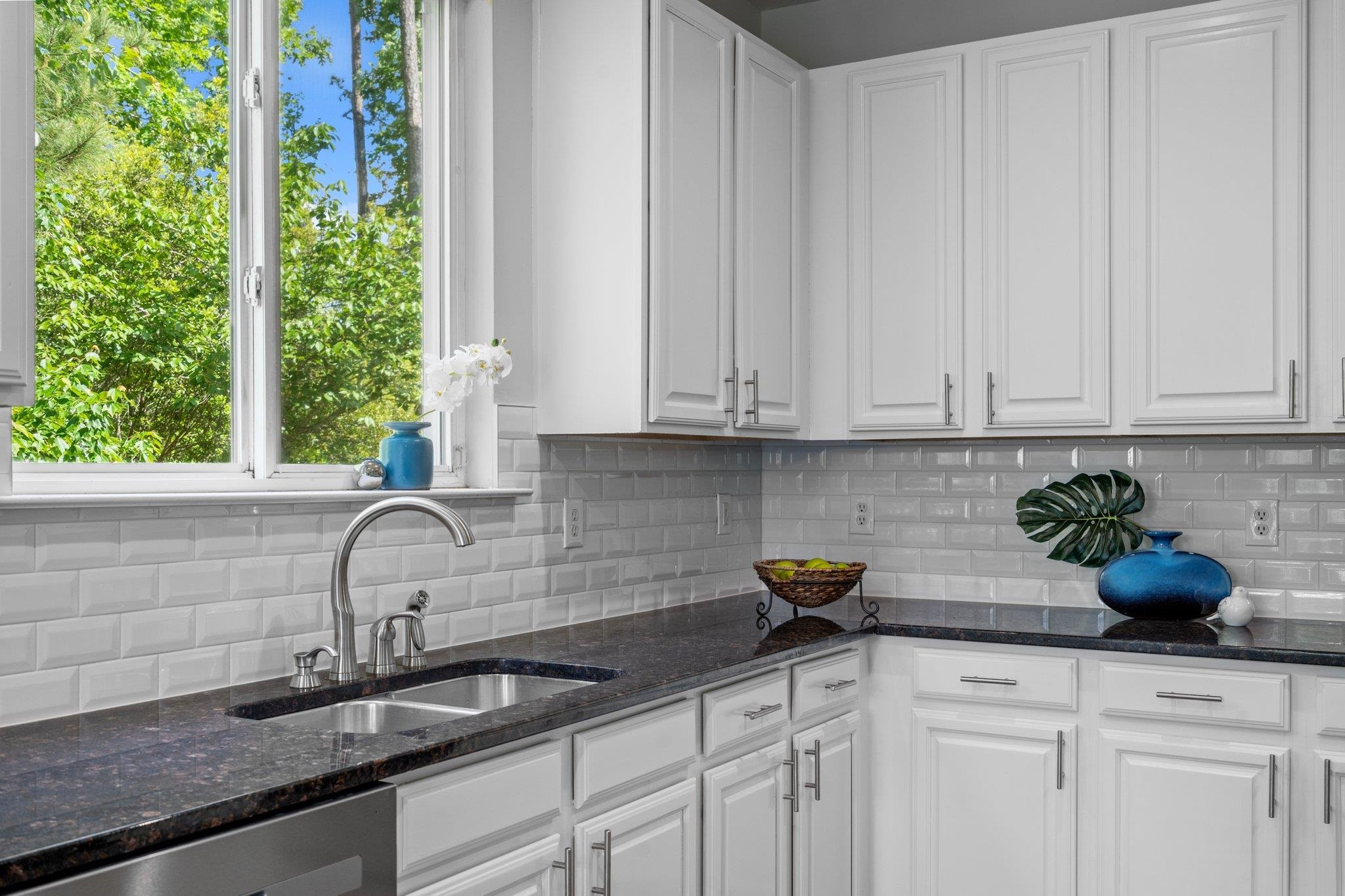 532 Emerald Downs Road Cary, NC 27519 - Photo 23 of 51 a kitchen with a sink a potted plant and cabinets