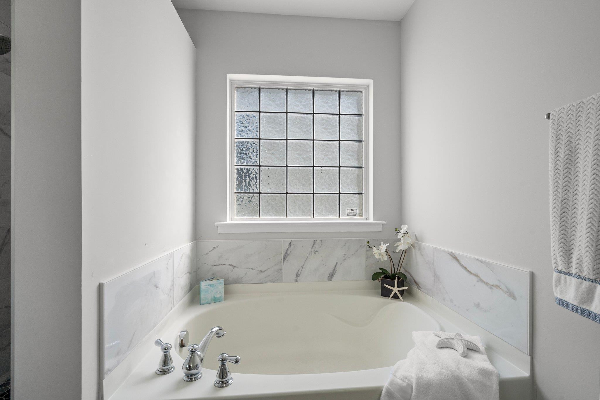 532 Emerald Downs Road Cary, NC 27519 - Photo 34 of 51 a bath tub sitting in a bathroom next to a window