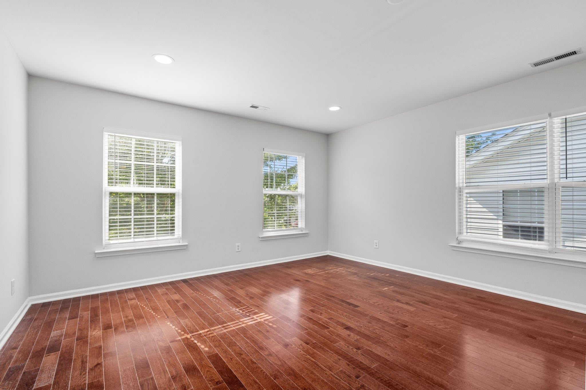 532 Emerald Downs Road Cary, NC 27519 - Photo 36 of 51 an empty room with wooden floor and windows