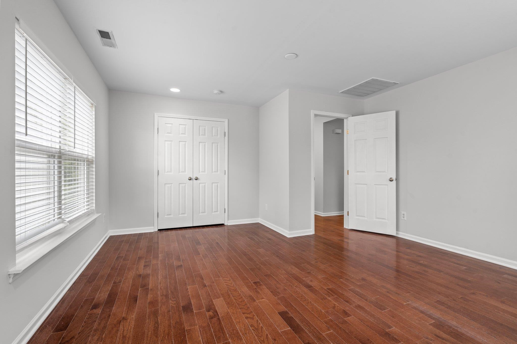 532 Emerald Downs Road Cary, NC 27519 - Photo 37 of 51 a view of an empty room with wooden floor and a window