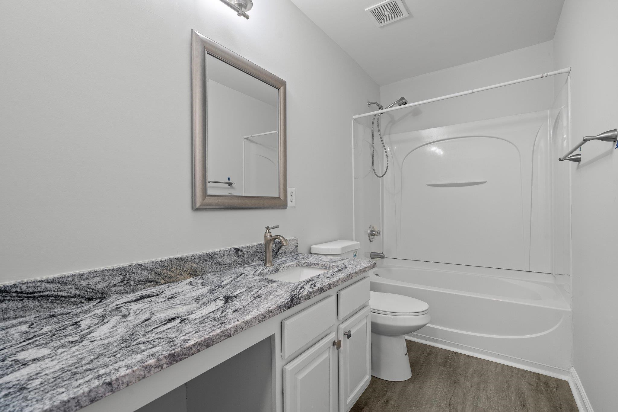 532 Emerald Downs Road Cary, NC 27519 - Photo 38 of 51 a bathroom with a granite countertop sink a toilet and shower