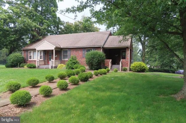 a front view of house with yard and green space
