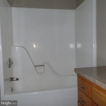 a bathroom with a sink a toilet and a window