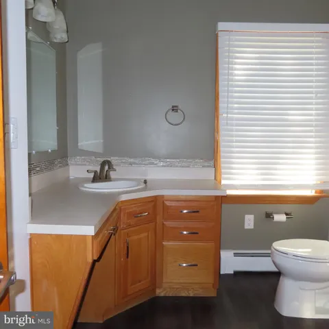 a white toilet sitting next to a bath tub