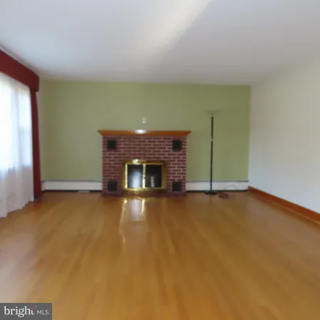 a view of an empty room with a fireplace