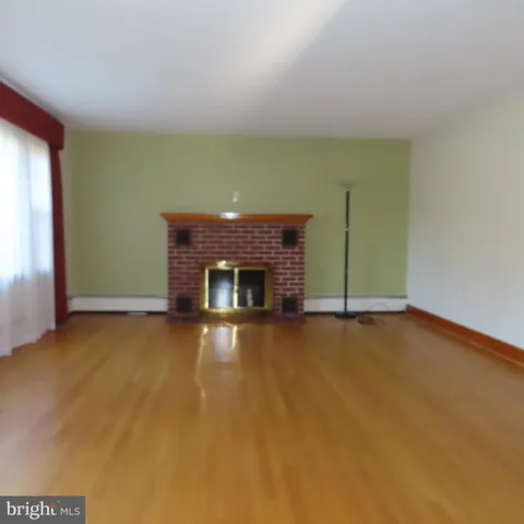 a view of an empty room with a fireplace