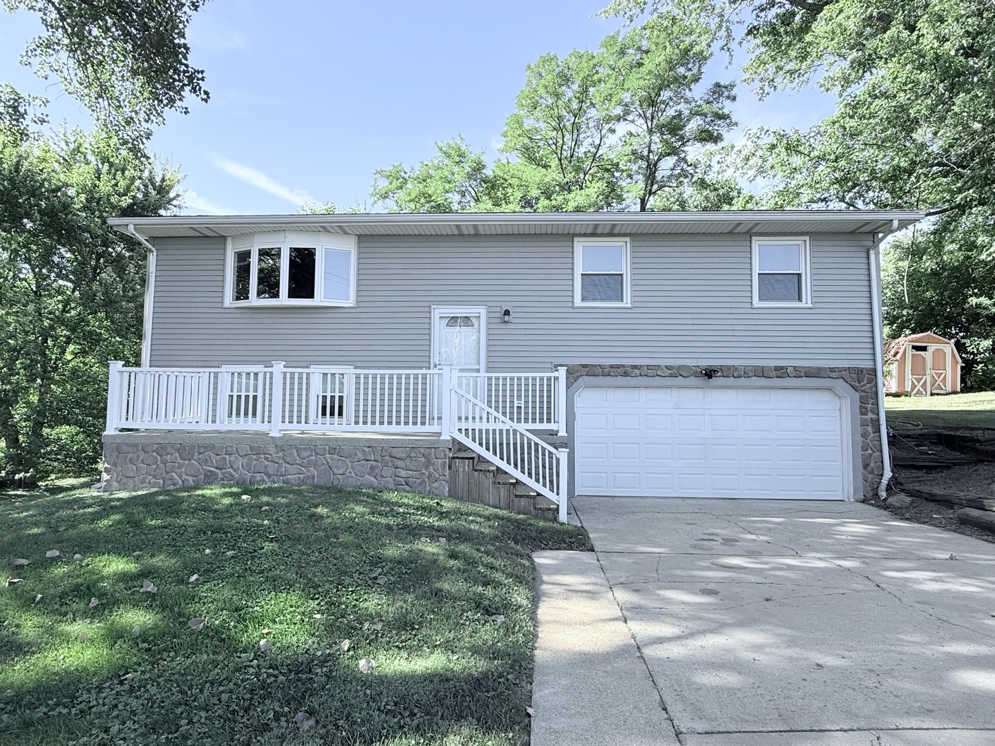 8824 Sunset Road Clinton, IL 61727 - Photo 1 of 24 a view of a house with a yard plants and large tree