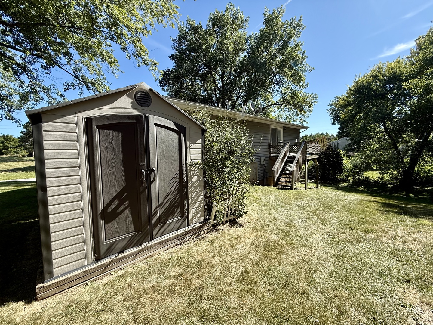 8824 Sunset Road Clinton, IL 61727 - Photo 22 of 24 a yellow house with a outdoor space