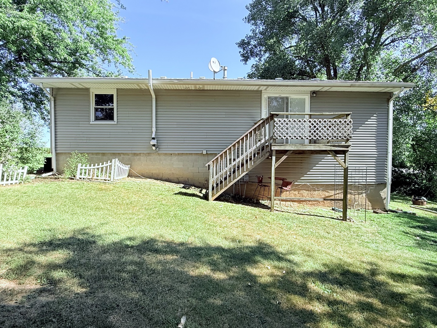 8824 Sunset Road Clinton, IL 61727 - Photo 23 of 24 a house with trees in the background