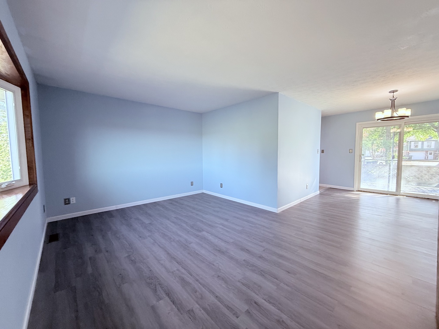 8824 Sunset Road Clinton, IL 61727 - Photo 5 of 24 an empty room with wooden floor and windows