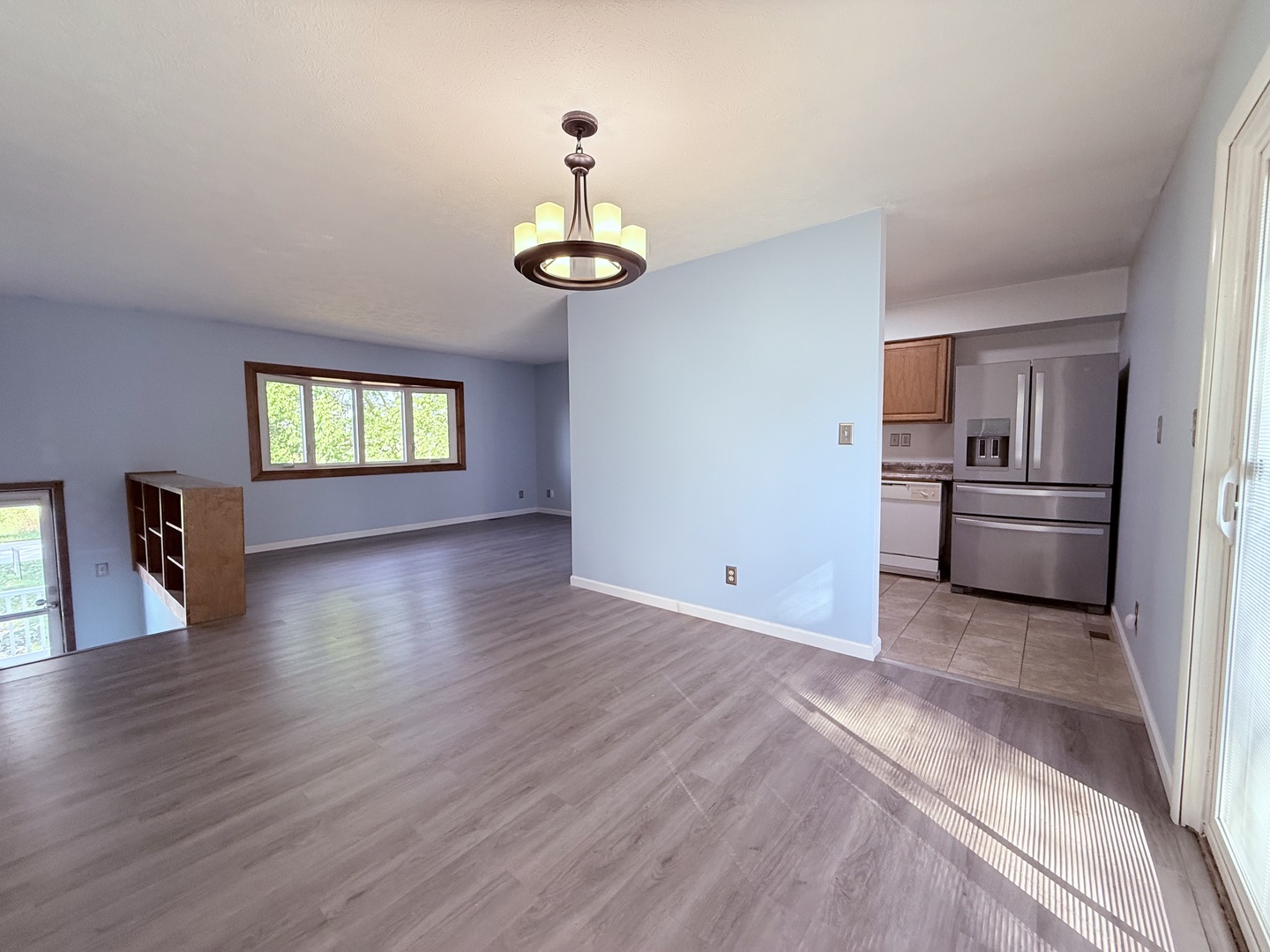 8824 Sunset Road Clinton, IL 61727 - Photo 7 of 24 a view of a kitchen with a sink dishwasher cabinets and a wooden floor