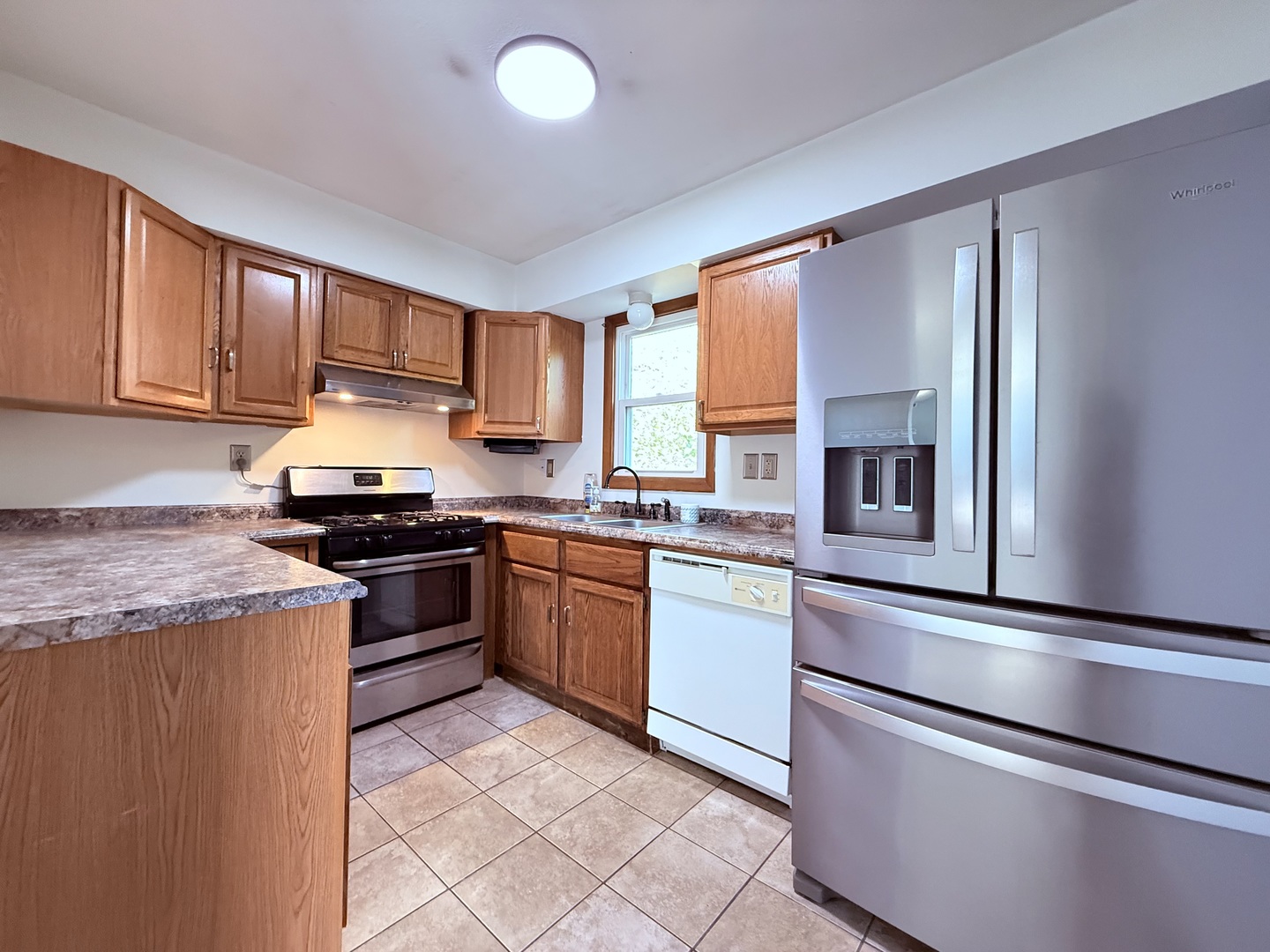 8824 Sunset Road Clinton, IL 61727 - Photo 8 of 24 a kitchen with granite countertop a refrigerator stove top oven and sink