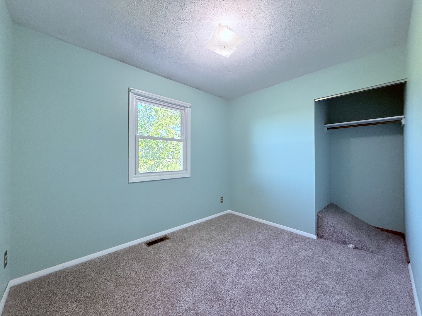 8824 Sunset Road Clinton, IL 61727 - Photo 10 of 24 an empty room with a window