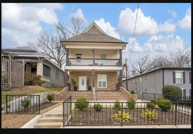 a front view of a house with garden