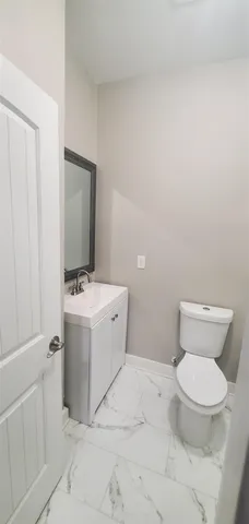 a white toilet sitting next to a bathroom sink