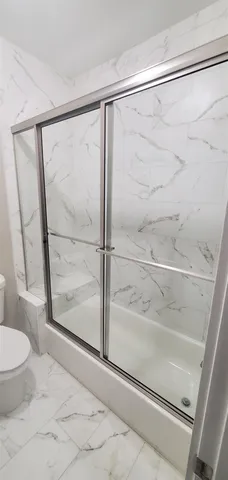 a bathroom with a shower and toilet