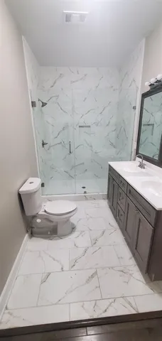 a bathroom with a granite countertop sink a shower and a mirror