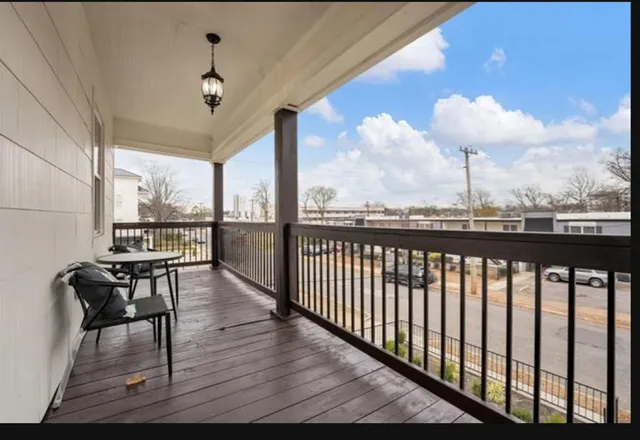 a view of a balcony with wooden floor