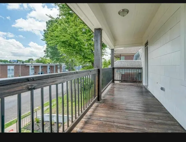 a terrace view with wooden floor and fence