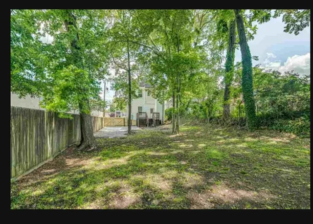 a view of a hallway with wooden floor and windows