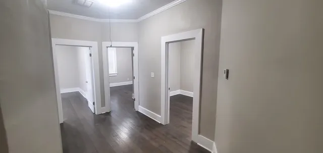 an empty room with closet and a window