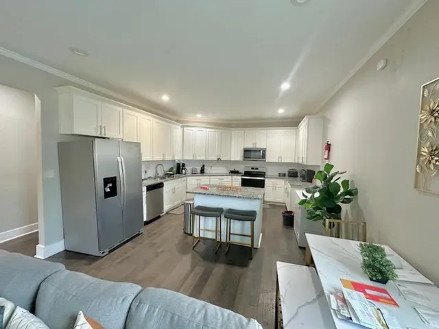 a kitchen with white cabinets and stainless steel appliances