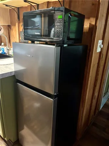 a view of a chair and table in backyard of the house