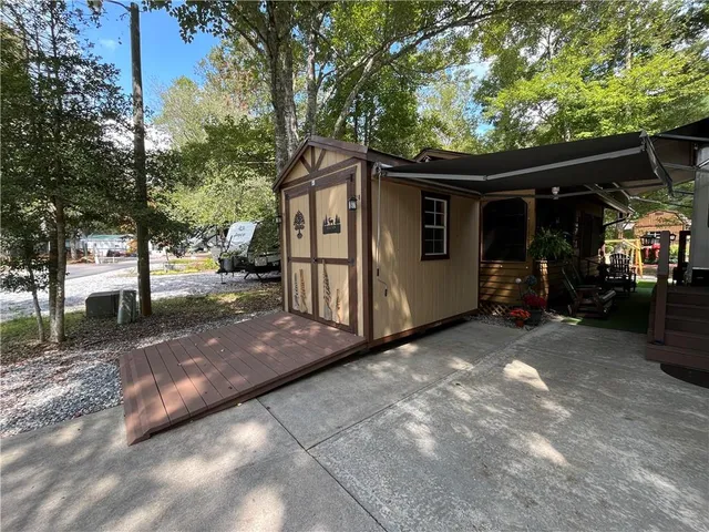 a view of a swimming pool with a patio and a yard