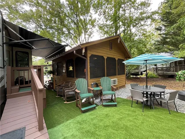 a view of a house with backyard porch and sitting area