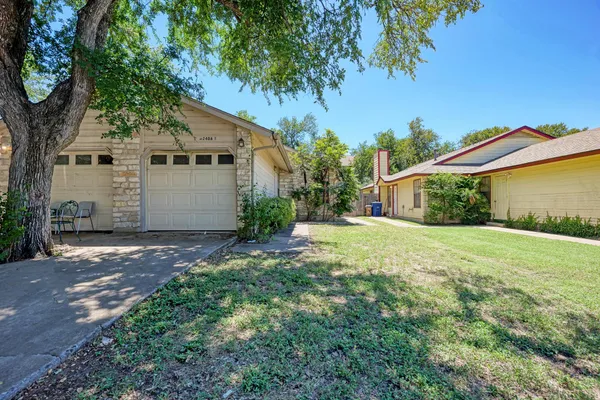 a view of a house with a yard