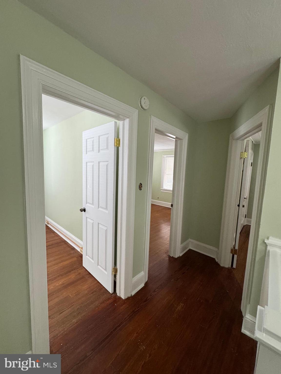 50 Broadship Road Dundalk, MD 21222 - Photo 16 of 30 an empty room with wooden floor and a fireplace