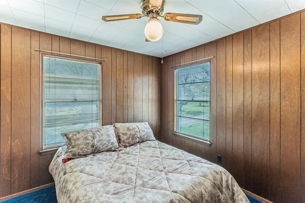 a large bed sitting in a bedroom next to a window