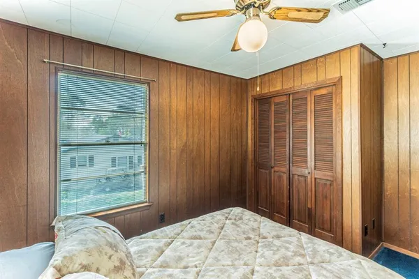 a bedroom with a bed and a window