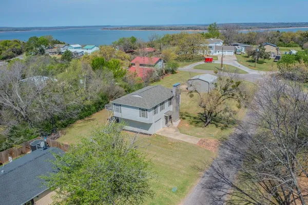 an aerial view of a house with a yard