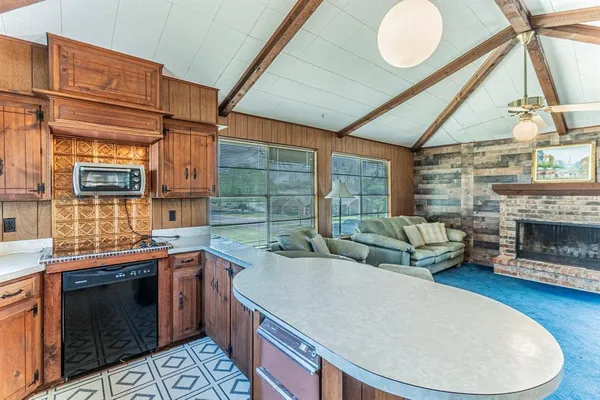 a kitchen with a stove a sink and a microwave