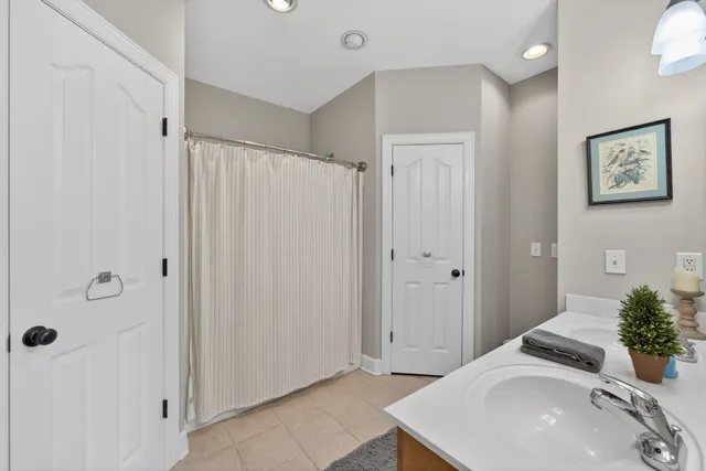 a bathroom with a sink a mirror and a shower