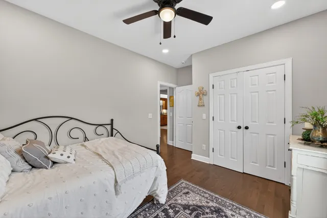 a bedroom with a bed and ceiling fan