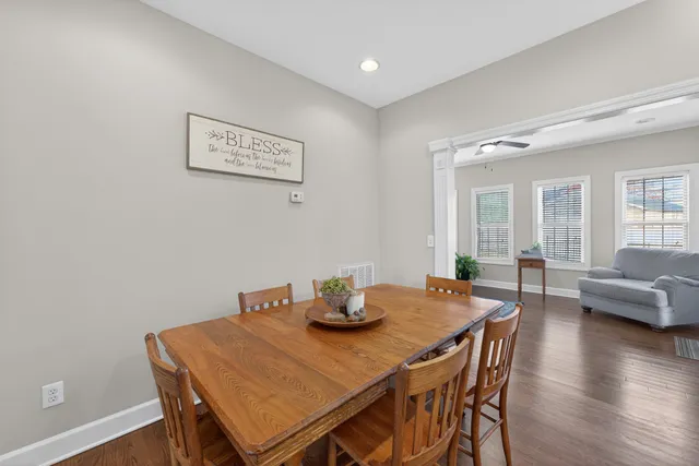 a dining room with furniture and wooden floor