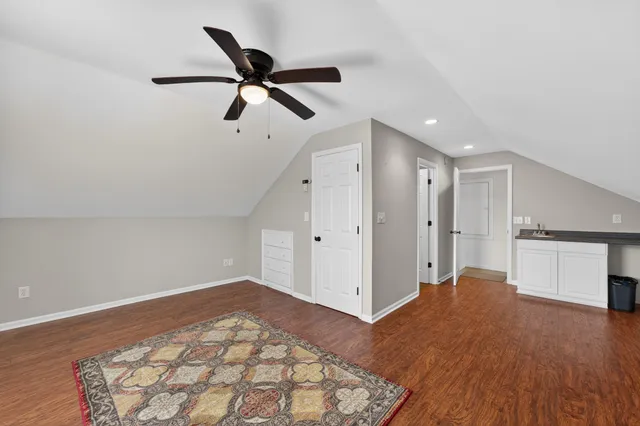a view of empty room with wooden floor and window