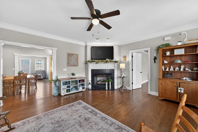 a living room with furniture fireplace and wooden floor