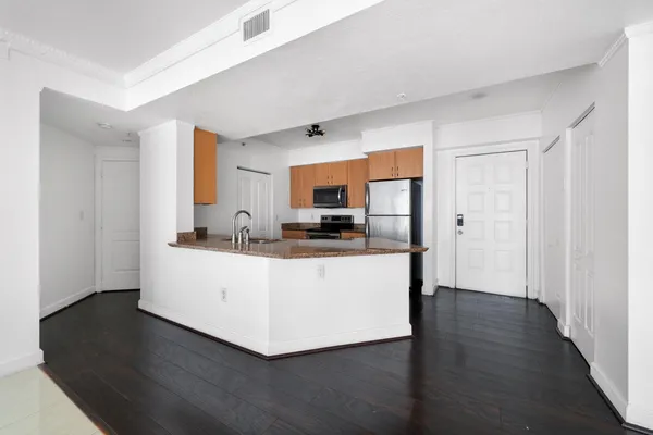a room with wooden floors and white walls