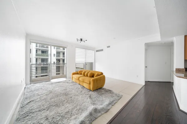 a living room with furniture and large windows
