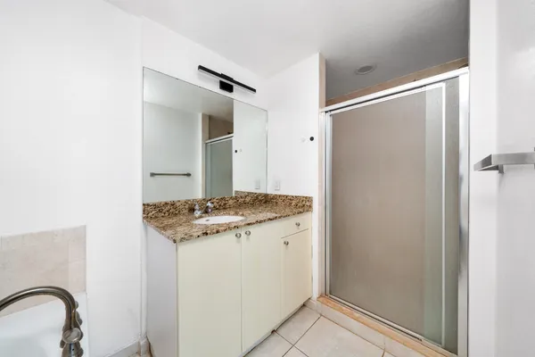 an empty room with wooden floor ceiling fan and windows